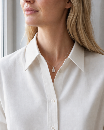 Clear quartz interchangeable pendant necklace worn in natural window light
