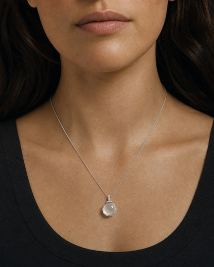 Clear quartz interchangeable pendant necklace worn close-up with natural skin texture