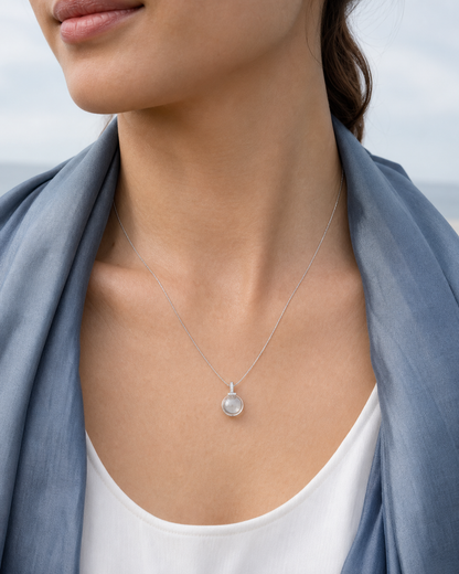 Clear quartz interchangeable pendant necklace styled with a gray-blue scarf